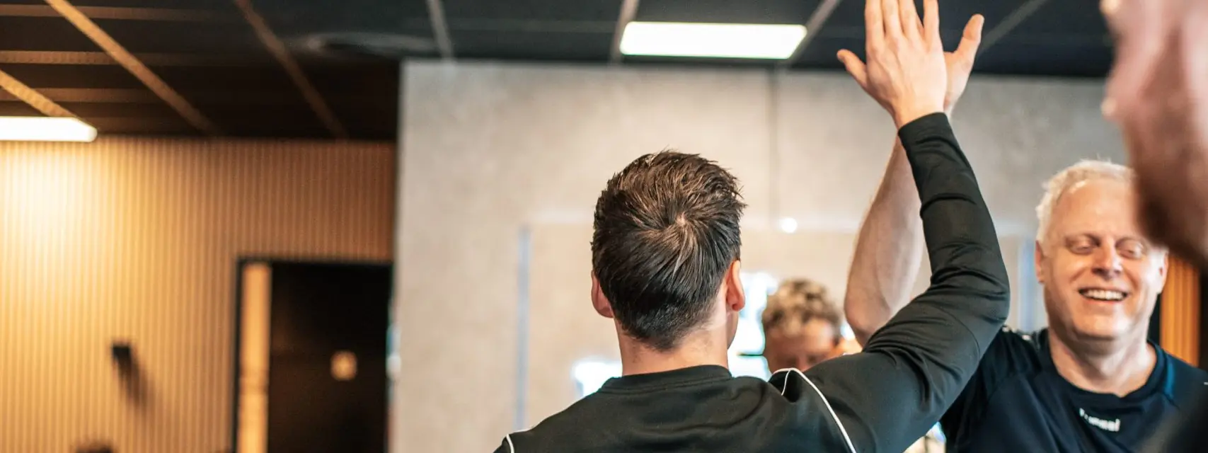 Twee leden geven elkaar een high five na de training